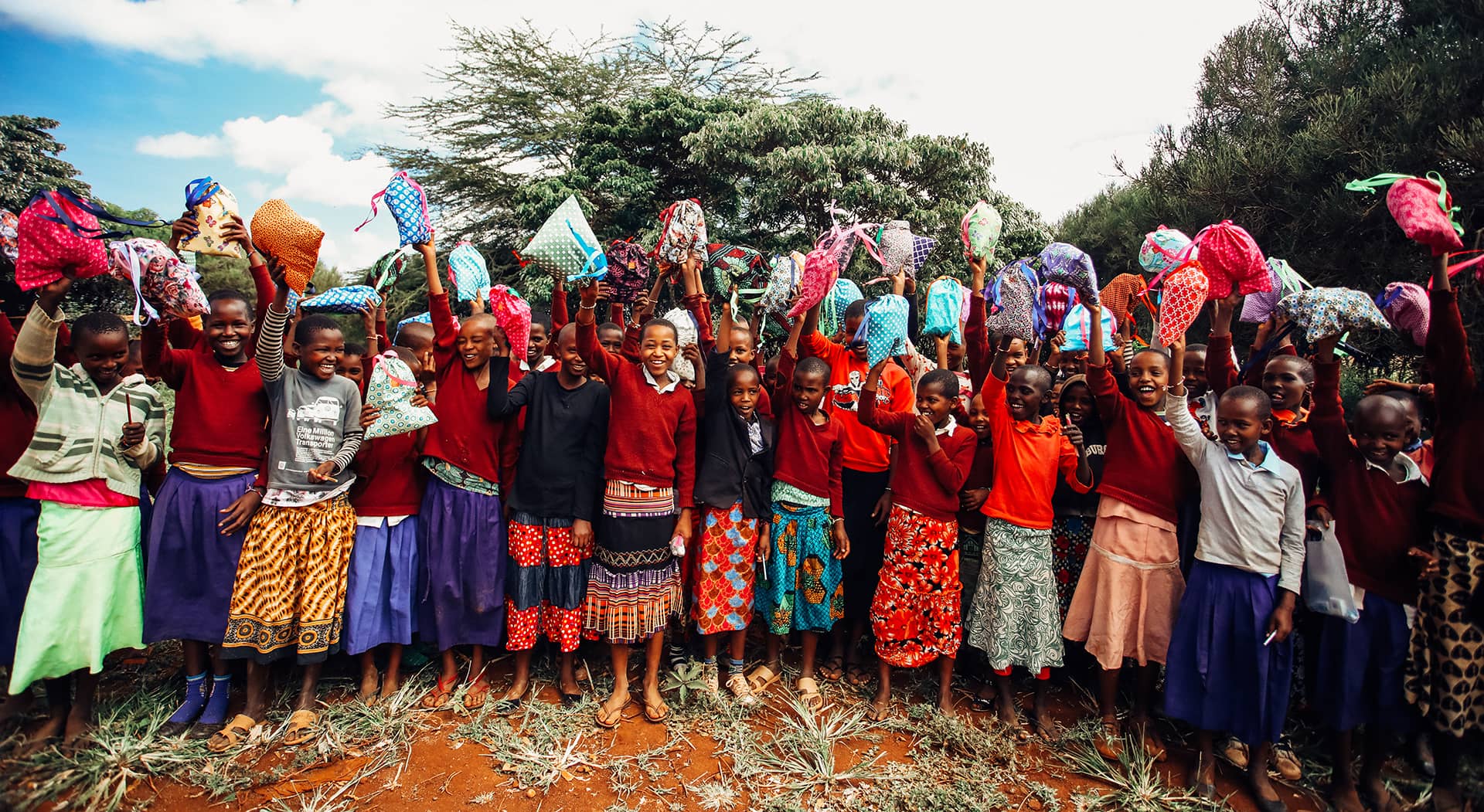 group of girls holding up their period kits