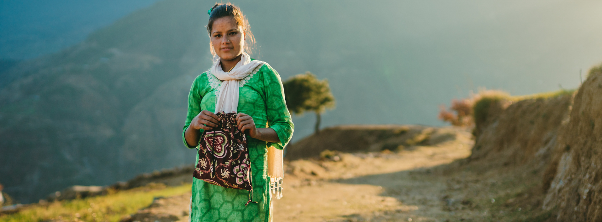 Woman standing on a sunlight hillside