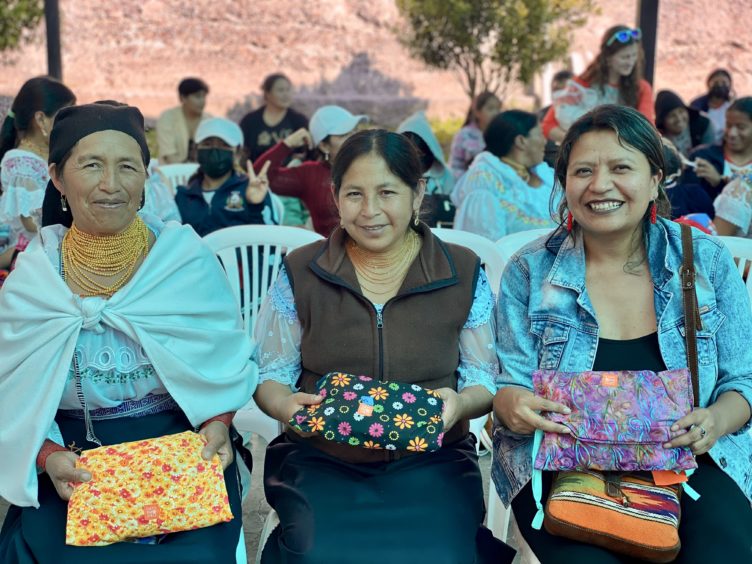three women seated while smiling