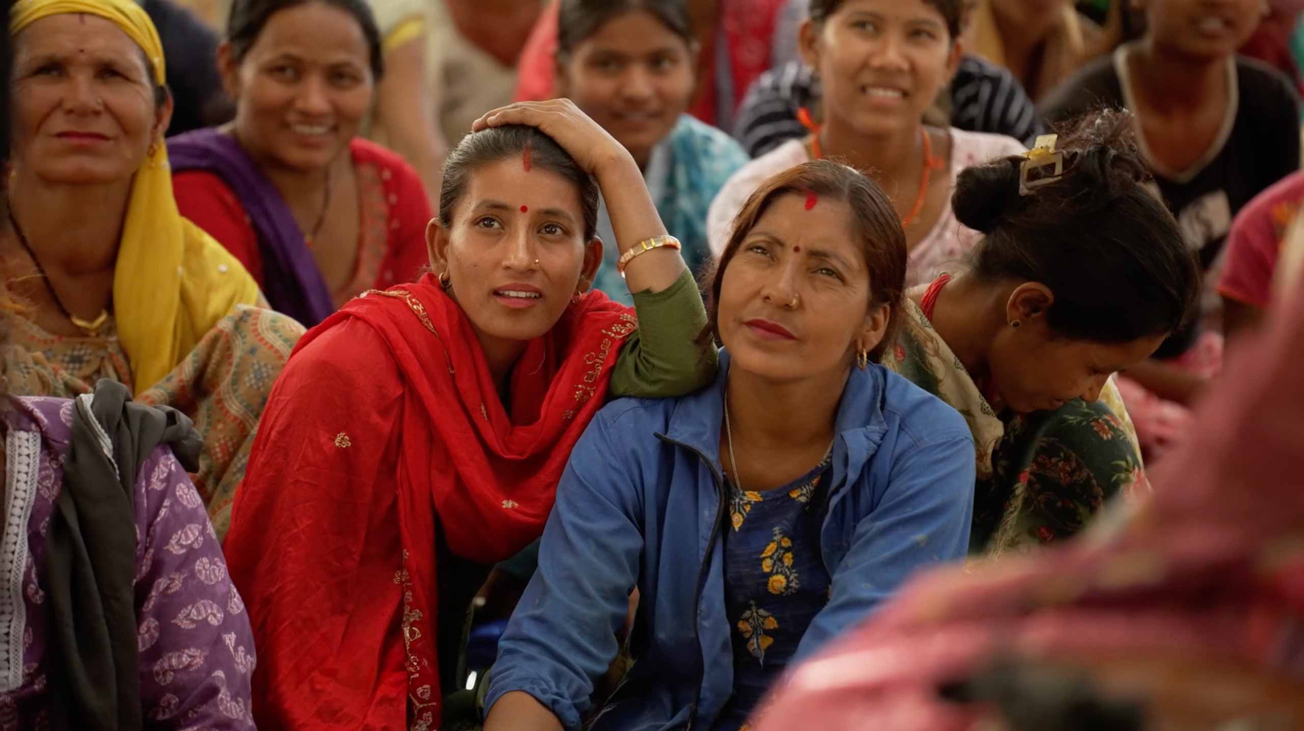 two Nepalese women focused on a presentation